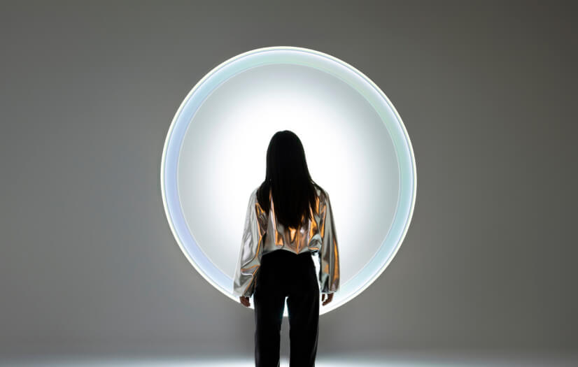 Woman looking into a ball of light