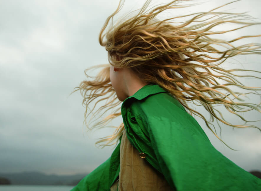 Woman dressed in green turns her head away